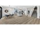 Kitchen and dining area with wood-look floors and modern light fixture at 3702 W Naomi Ln, San Tan Valley, AZ 85144