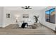 Living room with white sofa and wood-look floors at 3702 W Naomi Ln, San Tan Valley, AZ 85144