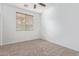 Well-lit bedroom with ceiling fan and carpet flooring at 3923 E Kesler Ln, Gilbert, AZ 85295