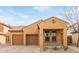 Tan two-story house with brown garage door and small front porch at 3923 E Kesler Ln, Gilbert, AZ 85295