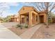 Tan house with a walkway leading to the front door and small yard at 3923 E Kesler Ln, Gilbert, AZ 85295