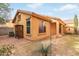 Rear view of a single story house with a small yard and shed at 3923 E Kesler Ln, Gilbert, AZ 85295