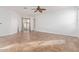 Living room with tile floors, sliding glass door, and ceiling fan at 3923 E Kesler Ln, Gilbert, AZ 85295