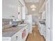 Clean white kitchen with tile countertops and wood flooring at 3955 W Cindy St, Chandler, AZ 85226