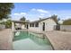 Attractive backyard with a private swimming pool, inviting patio, and mature landscaping, ideal for relaxation at 4059 E Cholla St, Phoenix, AZ 85028