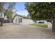 Expansive backyard featuring a well-maintained lawn and a view of the home's exterior at 4059 E Cholla St, Phoenix, AZ 85028