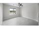 Bright, minimalist bedroom featuring tile floors, a ceiling fan, and a large window at 4059 E Cholla St, Phoenix, AZ 85028