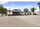 Charming single-story home with a modern garage door and well-maintained desert landscaping at 4059 E Cholla St, Phoenix, AZ 85028