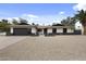 Inviting single-story home with desert landscaping, black framed windows, and modern garage door at 4059 E Cholla St, Phoenix, AZ 85028