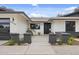 Contemporary home entrance showcasing a stylish black door and minimalist desert landscaping at 4059 E Cholla St, Phoenix, AZ 85028