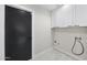 Laundry room featuring white cabinets and gray tile flooring at 4059 E Cholla St, Phoenix, AZ 85028