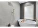 The main bathroom features a soaking tub, gold fixtures, and a gray tile surround at 4059 E Cholla St, Phoenix, AZ 85028