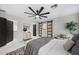 Spacious main bedroom with modern fan, rug, and sliding barn door to the bathroom at 4059 E Cholla St, Phoenix, AZ 85028