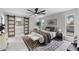 This bright main bedroom has a large rug, fan, and bathroom access through a sliding barn door at 4059 E Cholla St, Phoenix, AZ 85028