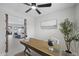 Bright office space featuring a wooden desk, globe, and a view into the open-concept living area at 4059 E Cholla St, Phoenix, AZ 85028