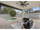 Relaxing covered patio featuring comfortable seating overlooking the pool and lush landscaping at 4059 E Cholla St, Phoenix, AZ 85028