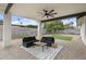 Inviting covered patio with stylish seating and a ceiling fan for relaxed outdoor living at 4059 E Cholla St, Phoenix, AZ 85028