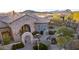 Luxury home with stone exterior, arched entry, and courtyard at 4208 N Via Cobre Cir, Mesa, AZ 85207