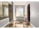 Elegant bathroom with soaking tub and glass block window at 4208 N Via Cobre Cir, Mesa, AZ 85207