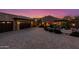 Elegant home exterior with a brick driveway and landscape lighting at 4208 N Via Cobre Cir, Mesa, AZ 85207