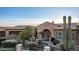 Stone house with arched entryway, fountain, and desert landscaping at 4208 N Via Cobre Cir, Mesa, AZ 85207