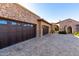 Three-car garage with dark brown doors and a brick facade at 4208 N Via Cobre Cir, Mesa, AZ 85207