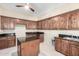 Laundry room with wooden cabinets, granite countertops, and an island at 4208 N Via Cobre Cir, Mesa, AZ 85207