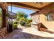 Covered patio with outdoor kitchen, bar, and backyard access at 4208 N Via Cobre Cir, Mesa, AZ 85207