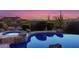 Luxury pool and spa with mountain views at sunset at 4208 N Via Cobre Cir, Mesa, AZ 85207