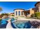 Resort-style pool and spa with expansive patio and stone accents at 4208 N Via Cobre Cir, Mesa, AZ 85207