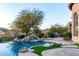 Luxury pool with waterfall, mountain views, and expansive patio at 4208 N Via Cobre Cir, Mesa, AZ 85207