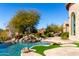 Luxury pool with waterfall feature, expansive patio, and mountain views at 4208 N Via Cobre Cir, Mesa, AZ 85207