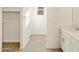 Bathroom with tiled floor, white cabinets, and a walk-in closet at 4267 W Jeanette Ln, San Tan Valley, AZ 85144