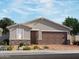 One-story home with brown garage door and stone accents at 4267 W Jeanette Ln, San Tan Valley, AZ 85144