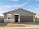 Inviting exterior features neutral stucco, stone accents, well-kept gravel landscaping, and a convenient two-car garage at 4267 W Jeanette Ln, San Tan Valley, AZ 85144