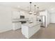 Bright open kitchen features an island with pendant lighting and modern stainless-steel appliances at 4287 W Jeanette Ln, San Tan Valley, AZ 85144