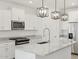 Close up of kitchen island with pendant lights, stainless steel appliances, and stone countertops at 4287 W Jeanette Ln, San Tan Valley, AZ 85144