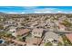 Wide aerial view of a residential neighborhood with a focus on a two-story house at 43815 W Carey Dr, Maricopa, AZ 85138