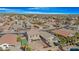 Aerial view of a house and neighborhood, showing the property's backyard and pool at 43815 W Carey Dr, Maricopa, AZ 85138