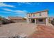 Large backyard with gravel, covered patio, and partial view of home at 43815 W Carey Dr, Maricopa, AZ 85138