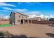 Large backyard with gravel, covered patio, and partial view of home at 43815 W Carey Dr, Maricopa, AZ 85138