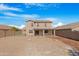 Large backyard with gravel, covered patio, and partial view of home at 43815 W Carey Dr, Maricopa, AZ 85138