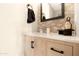 Modern bathroom with light wood vanity, hexagon tile, and a quartz countertop at 43815 W Carey Dr, Maricopa, AZ 85138