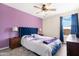 Bright bedroom with plush bed, nightstands, and ceiling fan at 43815 W Carey Dr, Maricopa, AZ 85138