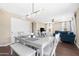 Dining area with light gray table and chairs, and modern light fixture at 43815 W Carey Dr, Maricopa, AZ 85138