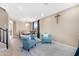 Bright dining room with a wooden table and teal chairs at 43815 W Carey Dr, Maricopa, AZ 85138