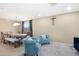 Dining area with wooden table and teal armchairs at 43815 W Carey Dr, Maricopa, AZ 85138