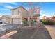 Two-story house with a beige exterior, two-car garage, and landscaped front yard at 43815 W Carey Dr, Maricopa, AZ 85138