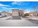 Two-story house with a beige exterior, two-car garage, and landscaped front yard at 43815 W Carey Dr, Maricopa, AZ 85138