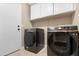 Bright laundry room featuring modern Samsung washer and dryer at 43815 W Carey Dr, Maricopa, AZ 85138